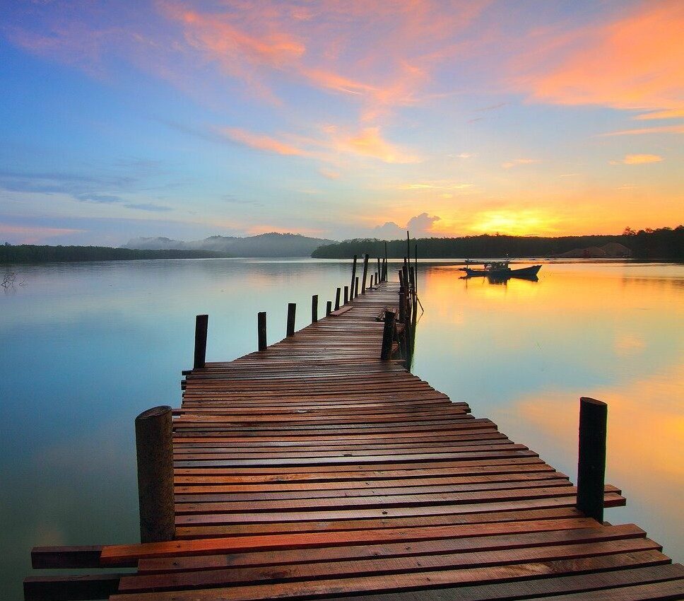 Sunrise over a lake and dock - mindful movement classes